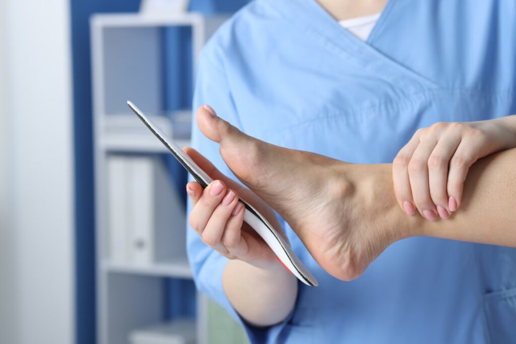 doctor fitting insole to patient s foot in hospita 2026 01 11 11 08 32 utc converted